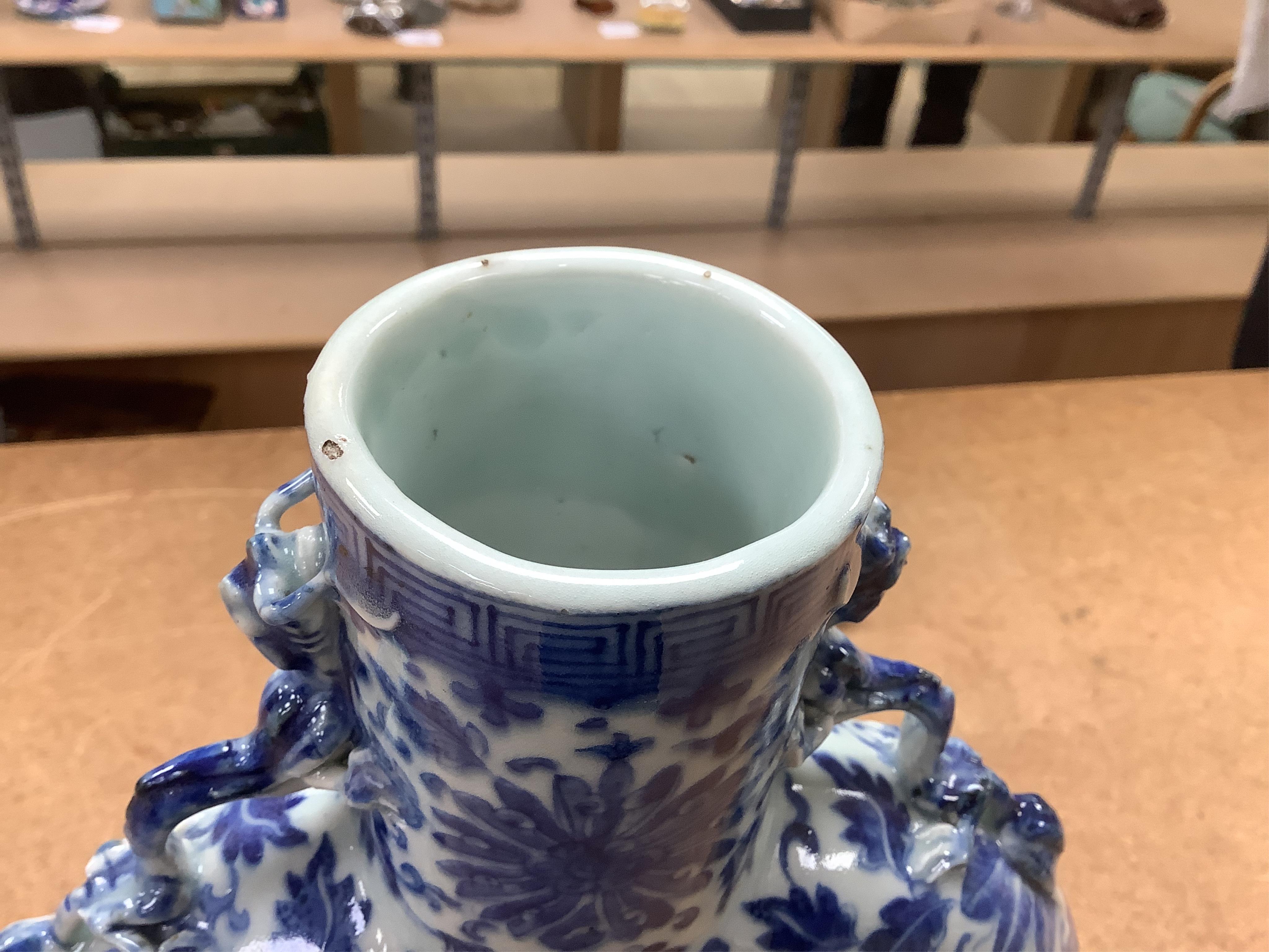 A 19th century Chinese blue and white moon flask on a hardwood stand, overall 35cm high. Condition - typical minor glaze imperfections